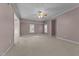 Spacious bedroom featuring carpeted floors, neutral walls, two windows, and a ceiling fan at 1818 Buxton Way, Burlington, NC 27215