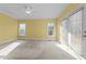 Sun-filled bedroom with a ceiling fan and access to a private balcony through glass doors at 1818 Buxton Way, Burlington, NC 27215