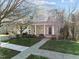 Charming brick front home with a welcoming porch and well-maintained landscaping at 1818 Buxton Way, Burlington, NC 27215