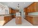 Well-lit kitchen with wood cabinets, light countertops and a center island at 1818 Buxton Way, Burlington, NC 27215