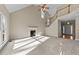 Large living room with fireplace, vaulted ceiling, and staircase at 1818 Buxton Way, Burlington, NC 27215