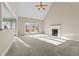 Bright living room with a cozy fireplace and large windows at 1818 Buxton Way, Burlington, NC 27215