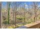 Secluded backyard view from the deck, surrounded by lush greenery and mature trees at 198 Ridge Trl, Chapel Hill, NC 27516