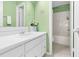 Bathroom featuring green walls, tile floors, sink, vanity, mirror, and bathtub with shower at 198 Ridge Trl, Chapel Hill, NC 27516