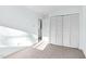 Bedroom with light blue walls, neutral carpet, and closet with bi-fold doors at 198 Ridge Trl, Chapel Hill, NC 27516