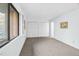 Bright bedroom featuring neutral carpet, a large window, and a closet with bi-fold doors at 198 Ridge Trl, Chapel Hill, NC 27516