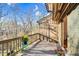 Outdoor deck with wooden planks and railing overlooking beautiful nature and sunlight in the morning at 198 Ridge Trl, Chapel Hill, NC 27516