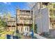 Exterior view of a multi-story home with wooden patios and a wooded yard at 198 Ridge Trl, Chapel Hill, NC 27516