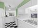 Bright kitchen open to the living room featuring classic checkerboard flooring and plenty of counter space at 198 Ridge Trl, Chapel Hill, NC 27516