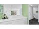 Bright kitchen featuring sleek white cabinetry, modern lighting, and open layout to the living area at 198 Ridge Trl, Chapel Hill, NC 27516