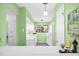 Bright kitchen features white cabinets and appliances, a window for natural light, and checkerboard floors at 198 Ridge Trl, Chapel Hill, NC 27516