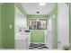 Updated kitchen with bright, natural light, checkerboard floors, and white appliances at 198 Ridge Trl, Chapel Hill, NC 27516