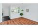 Inviting living room with wood floors, green light fixture, and view into the tiled front entry and kitchen at 198 Ridge Trl, Chapel Hill, NC 27516