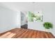 Bright living room with wood flooring and a view into the entryway and charming green and white kitchen at 198 Ridge Trl, Chapel Hill, NC 27516