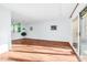 Open living room with hardwood floors, fireplace, and slider to balcony at 198 Ridge Trl, Chapel Hill, NC 27516