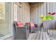 Cozy porch features wicker chairs, bright cushions, and vibrant flower box at 198 Ridge Trl, Chapel Hill, NC 27516