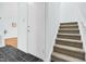 Front door and stair case featuring a neutral wall and a durable carpeted floor for comfort and style at 198 Ridge Trl, Chapel Hill, NC 27516