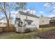 Rear view of a two-story house with white siding, a fenced yard, and a small deck at 2010 Blanchard St, Apex, NC 27502