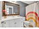 Bathroom with large framed mirror, white vanity, and decorative rainbow shower curtain at 2015 Stanchion St, Haw River, NC 27258