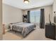 Cozy bedroom with neutral walls, carpet floors, and a large window providing ample natural light at 2015 Stanchion St, Haw River, NC 27258