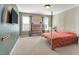 Bedroom with colorful rainbow decor, large windows, and a comfortable queen-sized bed at 2015 Stanchion St, Haw River, NC 27258