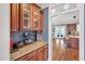 Butler's pantry featuring custom cabinetry, granite countertops, and seamless access to the kitchen at 2015 Stanchion St, Haw River, NC 27258