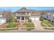 Stunning exterior of a two-story house featuring a well-manicured lawn, covered porch, and a three-car garage at 2015 Stanchion St, Haw River, NC 27258