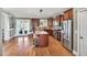 Beautiful kitchen features an island with seating, stainless steel appliances, hardwood floors and lots of cabinet space at 2015 Stanchion St, Haw River, NC 27258