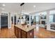 Open kitchen with island, granite countertops, hardwood floors, and seamless access to living and dining areas at 2015 Stanchion St, Haw River, NC 27258