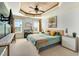 Inviting primary bedroom with a tray ceiling, abundant natural light, and a soothing color palette for ultimate relaxation at 2015 Stanchion St, Haw River, NC 27258