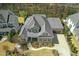 Aerial view of home showing the roof, driveway, landscaping, and surrounding neighborhood at 2046 Fellini Dr, Apex, NC 27502