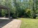 Beautiful backyard featuring a patio, gazebo, lush greenery, and manicured landscaping at 2046 Fellini Dr, Apex, NC 27502