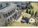 Aerial view of a backyard featuring a screened porch, deck with grill, and a gazebo with outdoor seating at 2046 Fellini Dr, Apex, NC 27502
