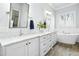 Bright bathroom with double vanity, marble countertop, a soaking tub, and wood look tile at 2046 Fellini Dr, Apex, NC 27502