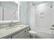 Well-lit bathroom featuring a white vanity with granite countertop and a combined shower and tub at 2046 Fellini Dr, Apex, NC 27502