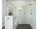 Close up of walk in shower with a bench, glass surround, dual shower heads, and stylish tile detail at 2046 Fellini Dr, Apex, NC 27502