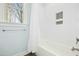 Inviting bathroom with a soaking tub, white tile, and natural light from the window at 2046 Fellini Dr, Apex, NC 27502