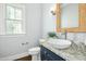 Stylish powder room featuring a vessel sink, granite countertop, and decorative mirror, adding elegance at 2046 Fellini Dr, Apex, NC 27502