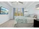 Airy bedroom featuring a cozy bed, large television, and scenic views from the expansive window at 2046 Fellini Dr, Apex, NC 27502