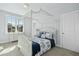 Bright bedroom with a canopy bed, soft color palette, and large windows that offer lots of natural light at 2046 Fellini Dr, Apex, NC 27502