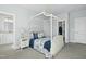 Stylish bedroom with a four-poster bed, soft lighting, and ensuite bathroom and closet at 2046 Fellini Dr, Apex, NC 27502
