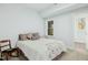 Cozy bedroom featuring natural light, a comfortable bed, and a charming accent chair at 2046 Fellini Dr, Apex, NC 27502