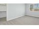Minimal bedroom design featuring plush carpeting and a window with natural light, plus an adjacent closet at 2046 Fellini Dr, Apex, NC 27502