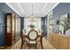 Inviting dining room with a wooden table, elegant chandelier, and large windows for natural light at 2046 Fellini Dr, Apex, NC 27502