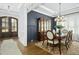 Elegant dining room featuring a dark wood table, stylish chairs, and a decorative hutch at 2046 Fellini Dr, Apex, NC 27502