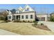 Charming brick home featuring a two-car garage, well-manicured lawn, and inviting curb appeal at 2046 Fellini Dr, Apex, NC 27502