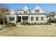 Charming two-story home with a brick facade, a covered front porch, and well-manicured landscaping at 2046 Fellini Dr, Apex, NC 27502