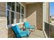 Cozy porch with blue patio chairs, perfect for enjoying outdoor living with shade and protection at 2046 Fellini Dr, Apex, NC 27502