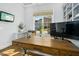 Bright home office featuring a large wooden desk, built-in shelves, and a window with neighborhood views at 2046 Fellini Dr, Apex, NC 27502