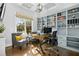 Home office with built-in shelving, a large window for natural light, and comfortable seating at 2046 Fellini Dr, Apex, NC 27502